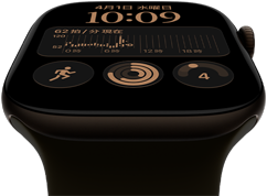 ダークブロンズのアルミニウムケースのApple Watch Series 12。モジュラーの文字盤に、曜日と日付、ワークアウト、アクティビティリング、Apple Musicのコンプリケーションが表示されている。外観の右側面にはDigital Crown。オリーブのスポーツバンド