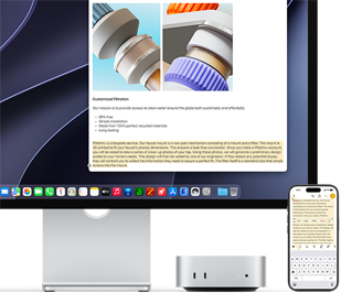 Studio Displayの下に収納されたMac miniの前面。Mac miniとStudio Displayの右側にiPhoneが置かれている。iPhoneの画面の上部でテキストが選択され、カット、コピー、ペースト、自動入力コマンドが表示されている。Studio Display上でも同じテキストがハイライトされており、ユニバーサルクリップボードを使っている様子を示している